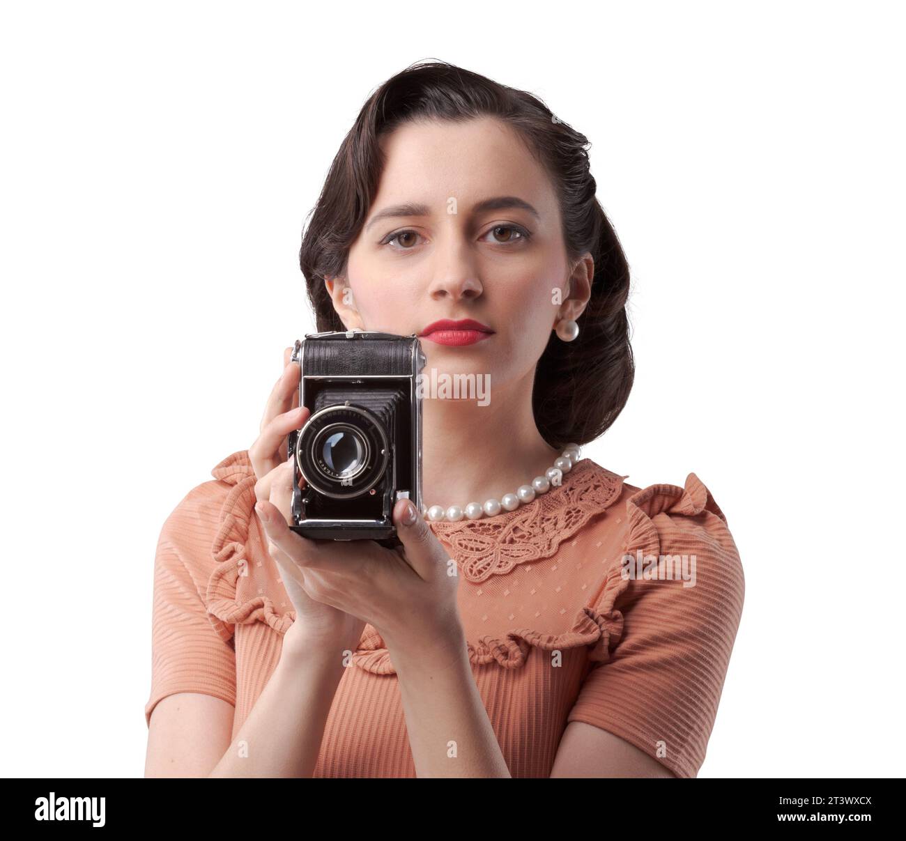 Beautiful elegant woman taking pictures with a vintage camera Stock Photo