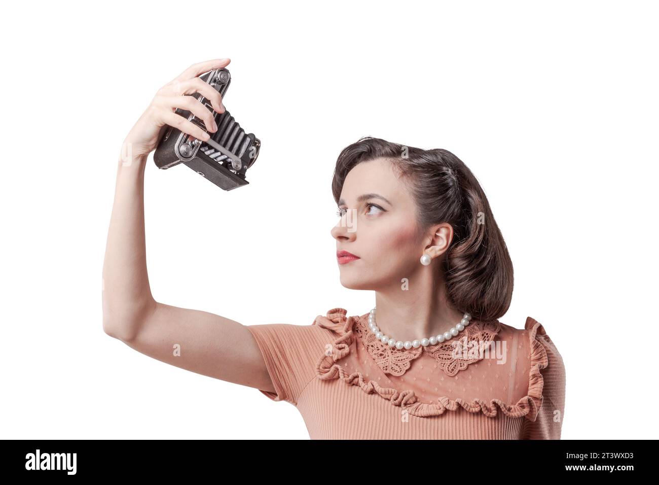 Beautiful elegant woman taking a self-portrait with a vintage camera Stock Photo