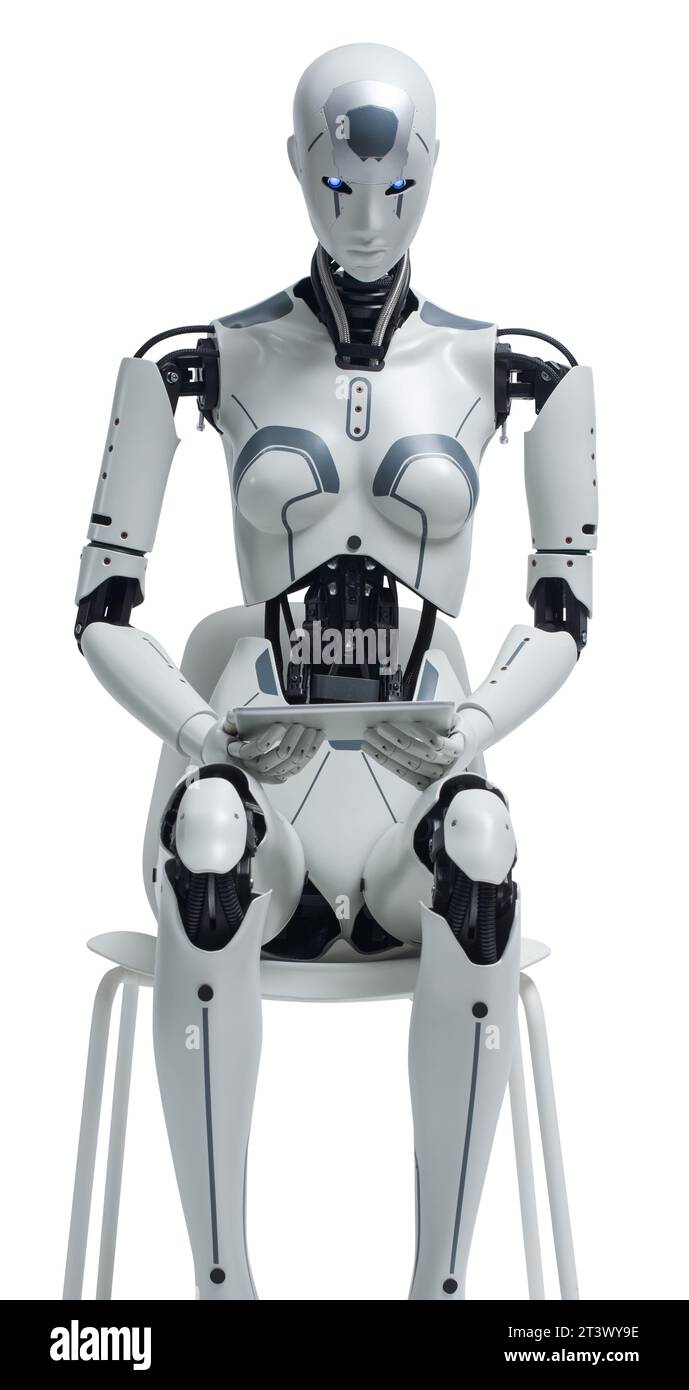 AI humanoid robot sitting on a chair and using a tablet Stock Photo