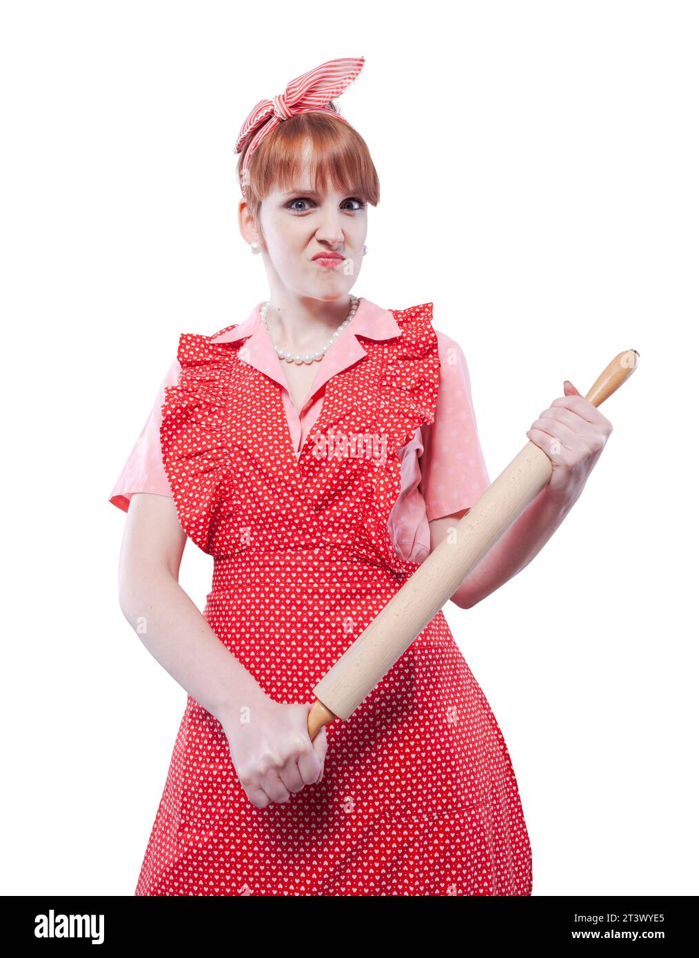 Aggressive angry vintage style housewife holding a rolling pin and looking at camera Stock Photo