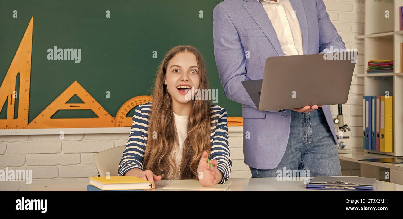 surprised kid with teacher in classroom use laptop Stock Photo - Alamy