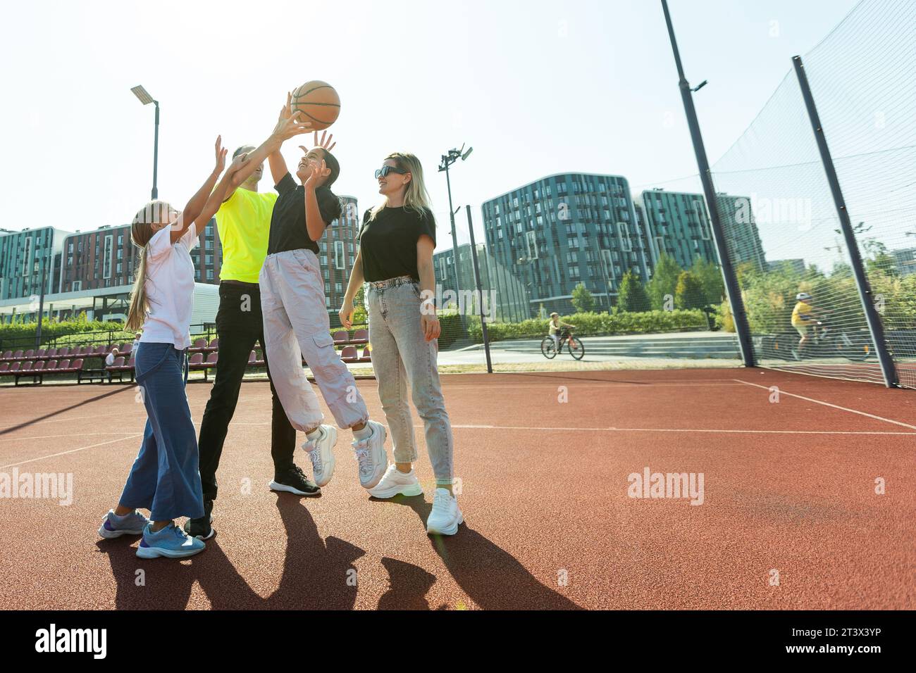 family playing basketball on court Stock Photo - Alamy