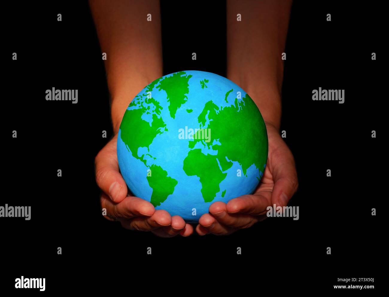 Pair of hands cradle a globe with lush green continents against a stark ...