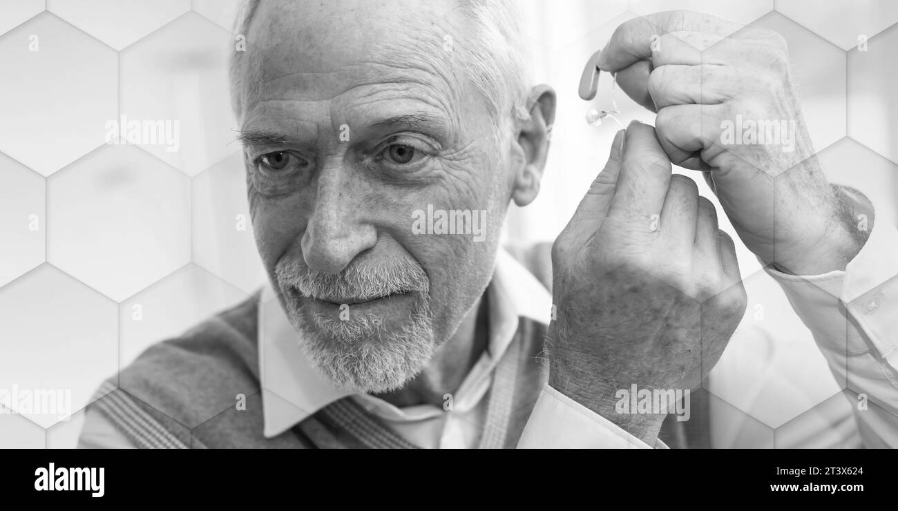Senior man putting hearing aids, geometric pattern Stock Photo Alamy