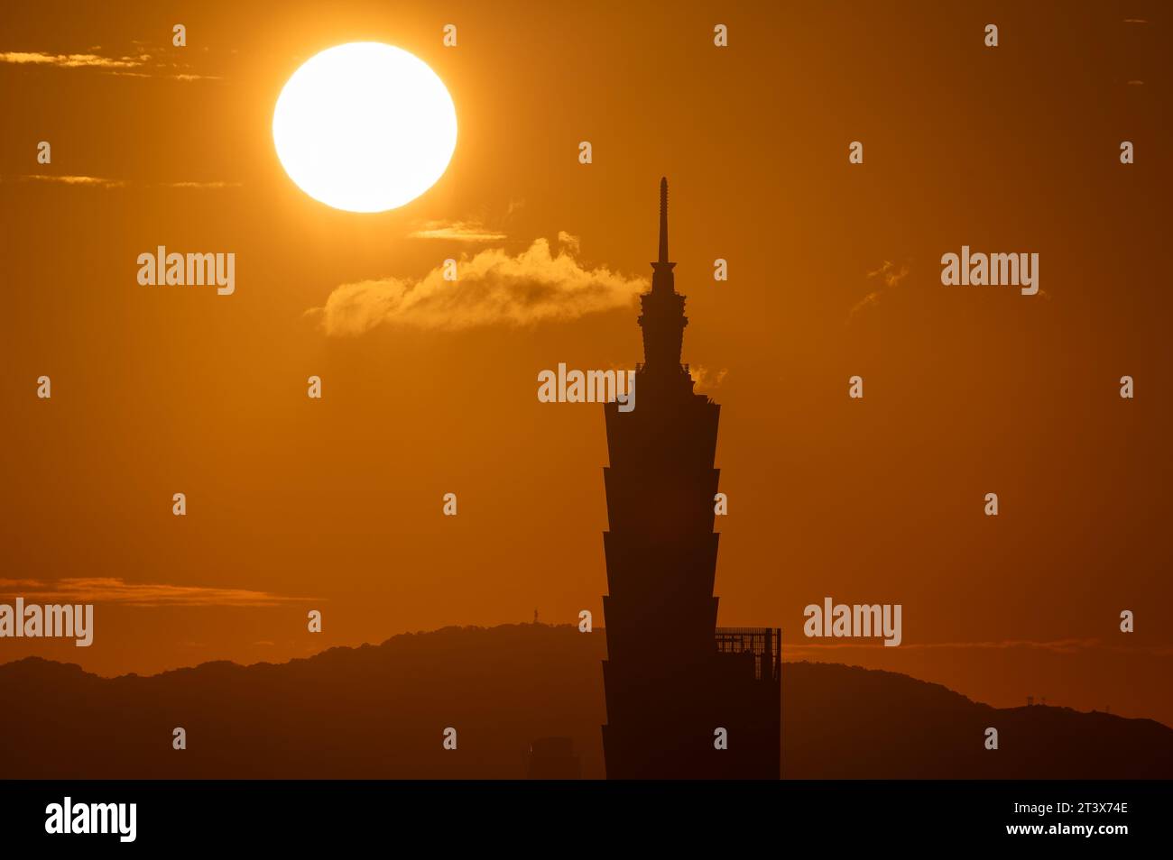 A combined view of the moving sun and city tower landmarks at sunset ...