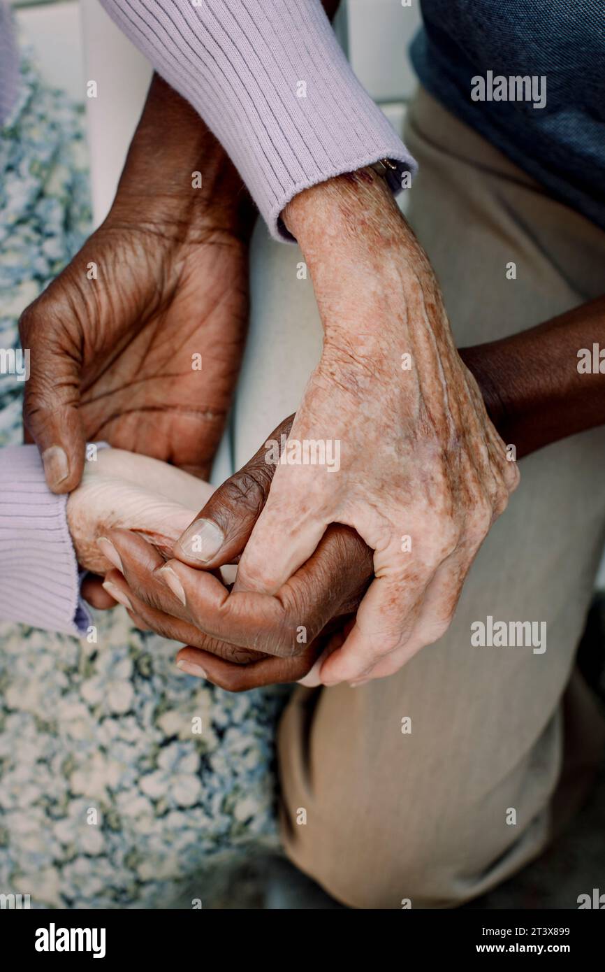 Midsection of senior man and woman holding hands Stock Photo