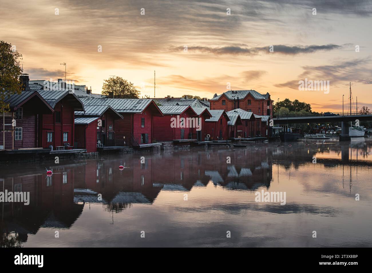 Red wooden houses on the canal at sunrise in Porvoo, Finland Stock Photo