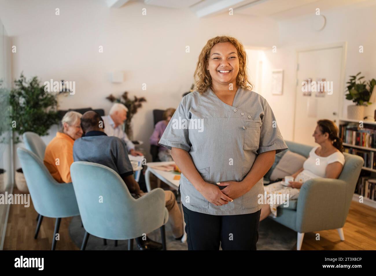 Portrait smiling nurse standing hi-res stock photography and images - Alamy