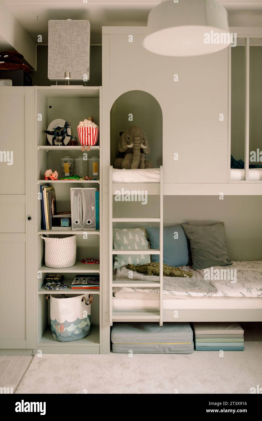 Bunkbed with toys in rack at home Stock Photo