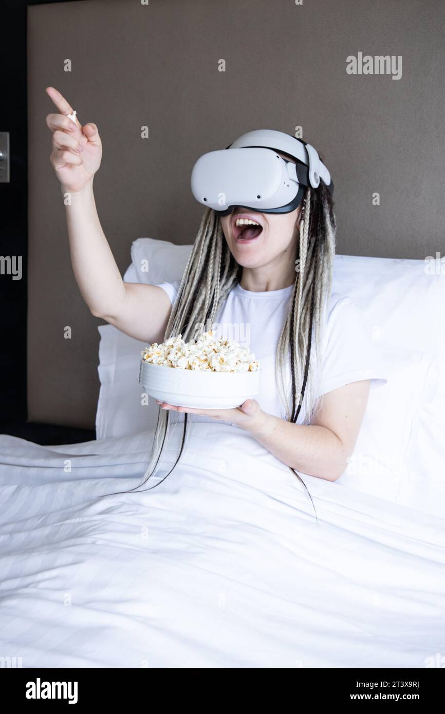 Young women with dreadlocks is using virtual reality helmet Stock Photo