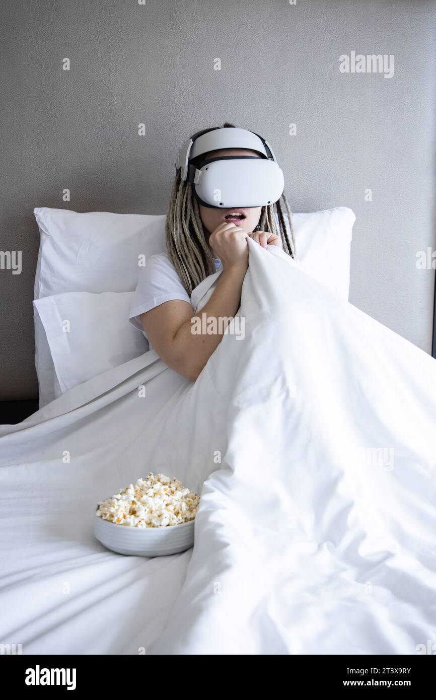 Young women with dreadlocks is using virtual reality helmet Stock Photo