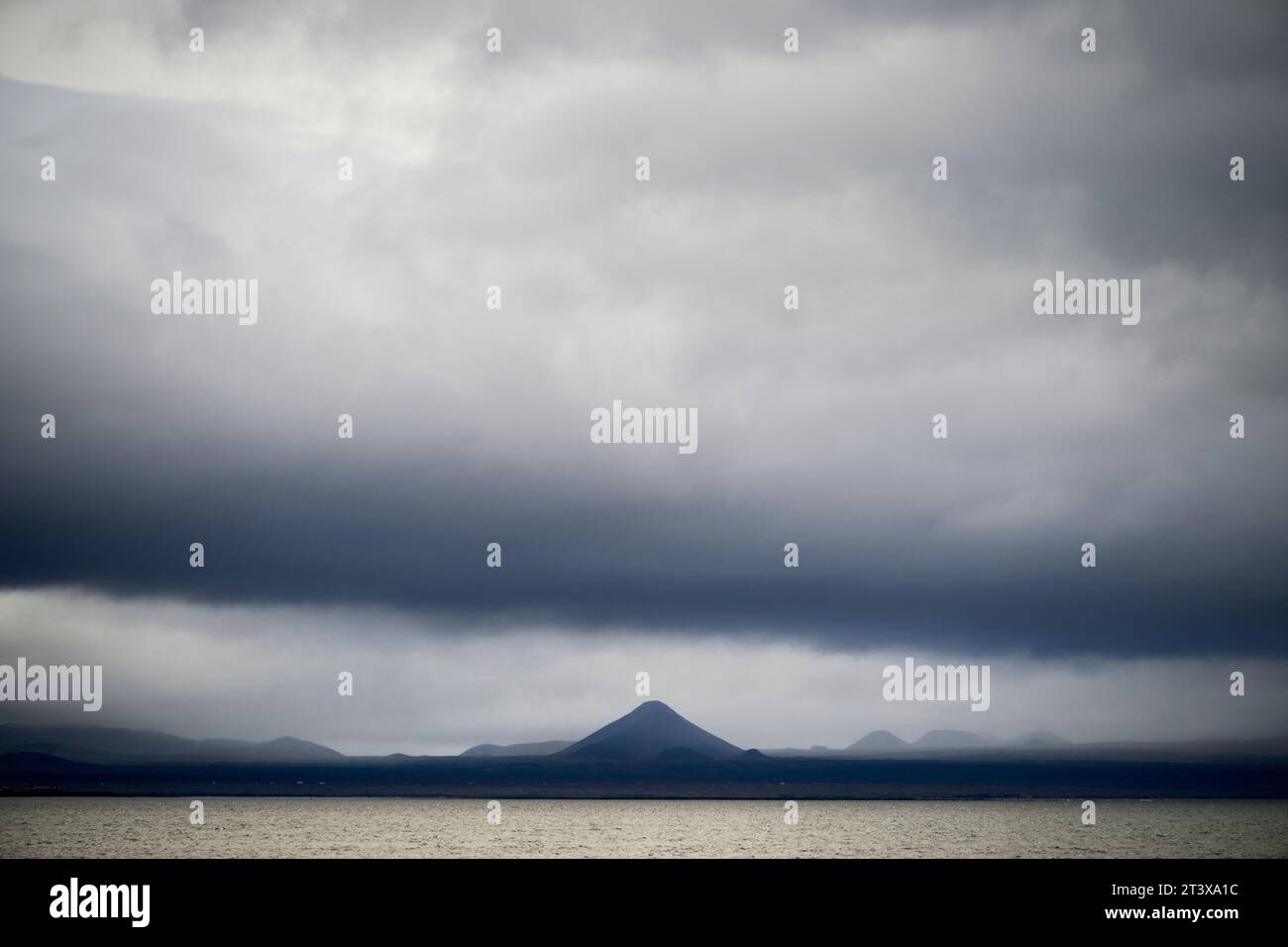 Cloudy dramatic sky over mountains and sea Stock Photo