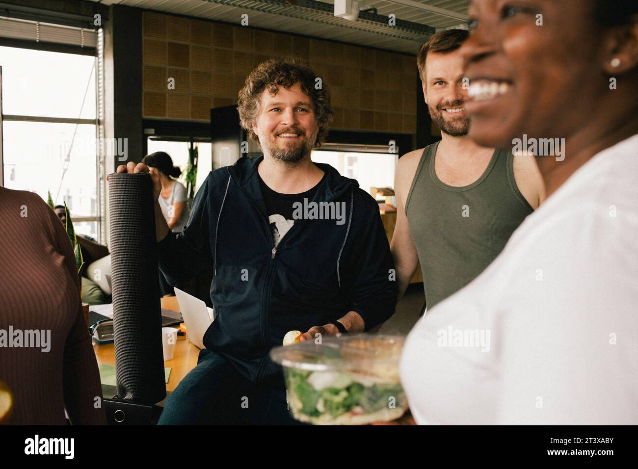Happy multiracial colleagues talking at office Stock Photo