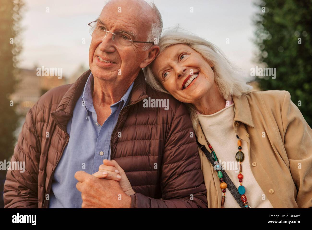 Happy affectionate senior couple holding hands Stock Photo
