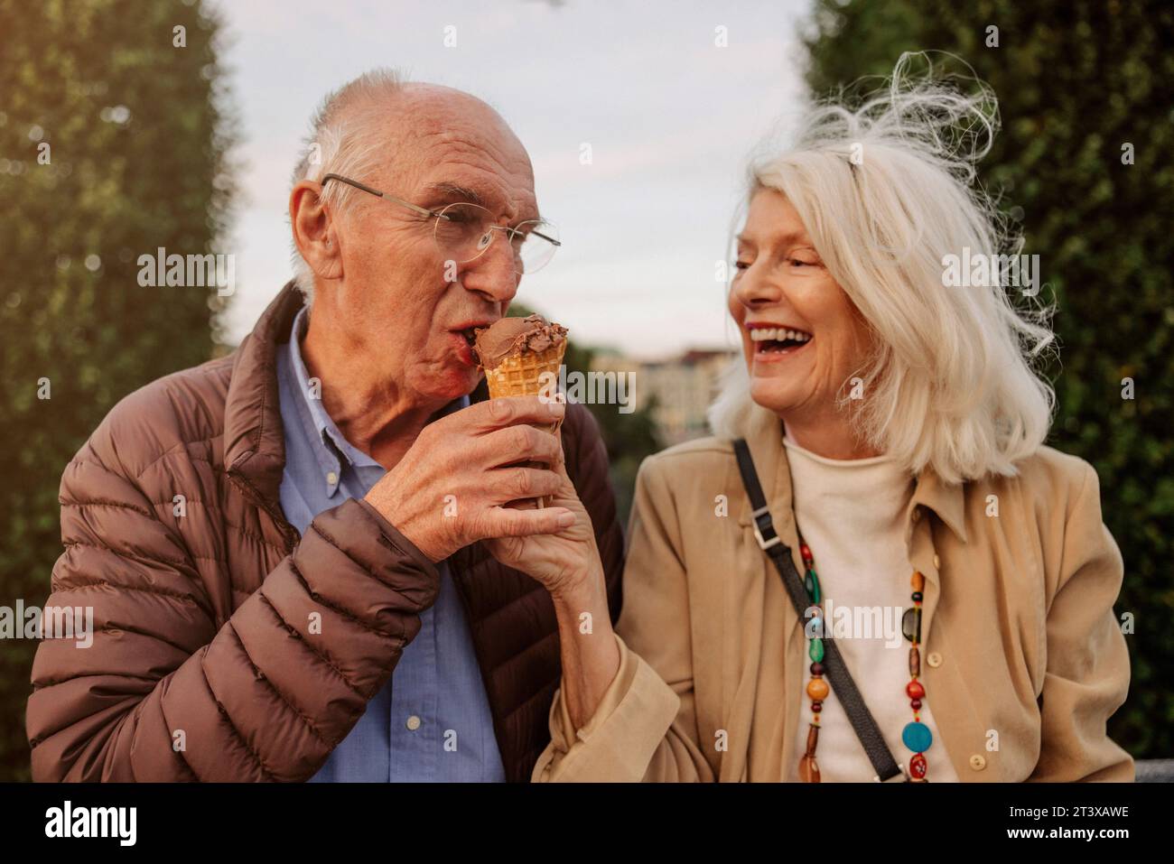 Happy senior couple sharing ice cream Stock Photo