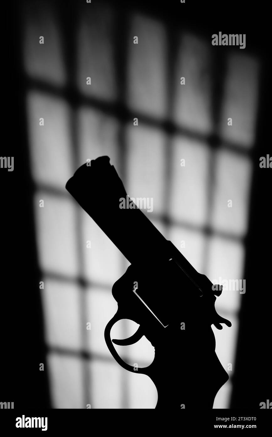 Pistol gun thriller book cover design photo with dramatic dark and light at night. Stock Photo