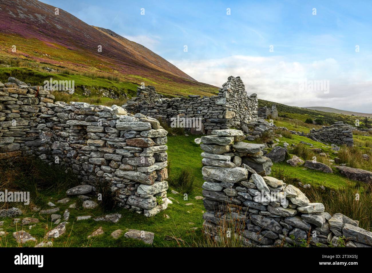 Slievemore Deserted Village is a protected archaeological site and a popular tourist destination, offering visitors a glimpse into traditional Irish l Stock Photo