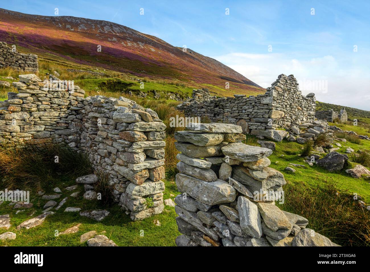 Slievemore Deserted Village is a protected archaeological site and a popular tourist destination, offering visitors a glimpse into traditional Irish l Stock Photo
