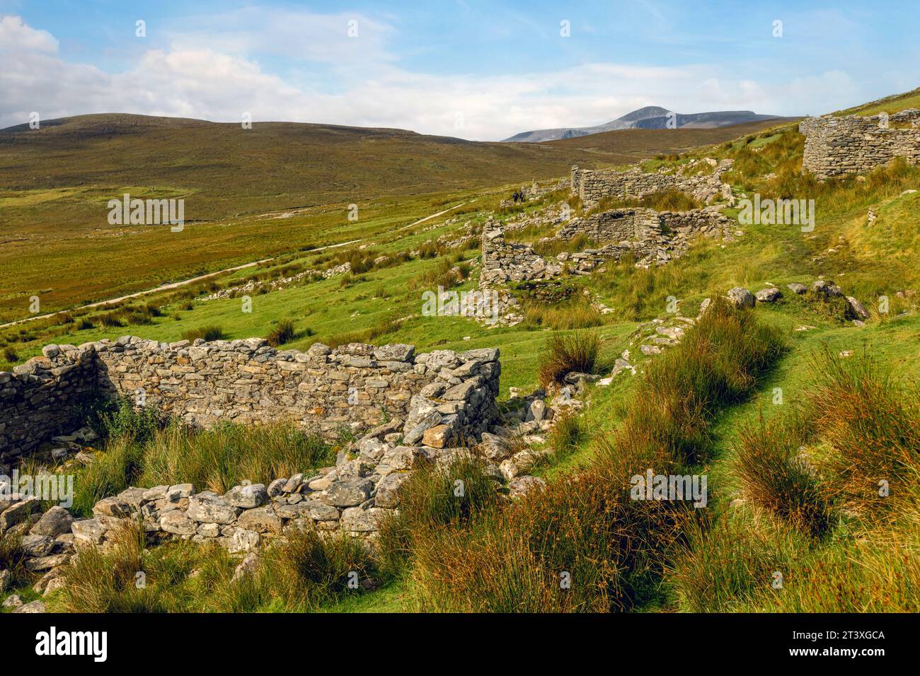 Slievemore Deserted Village is a protected archaeological site and a popular tourist destination, offering visitors a glimpse into traditional Irish l Stock Photo