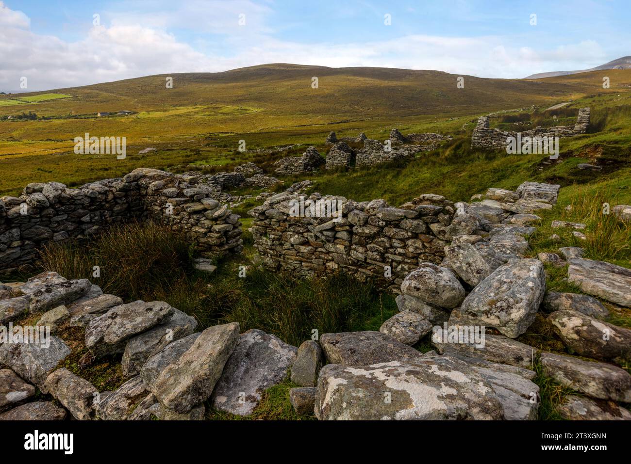 Slievemore Deserted Village is a protected archaeological site and a popular tourist destination, offering visitors a glimpse into traditional Irish l Stock Photo