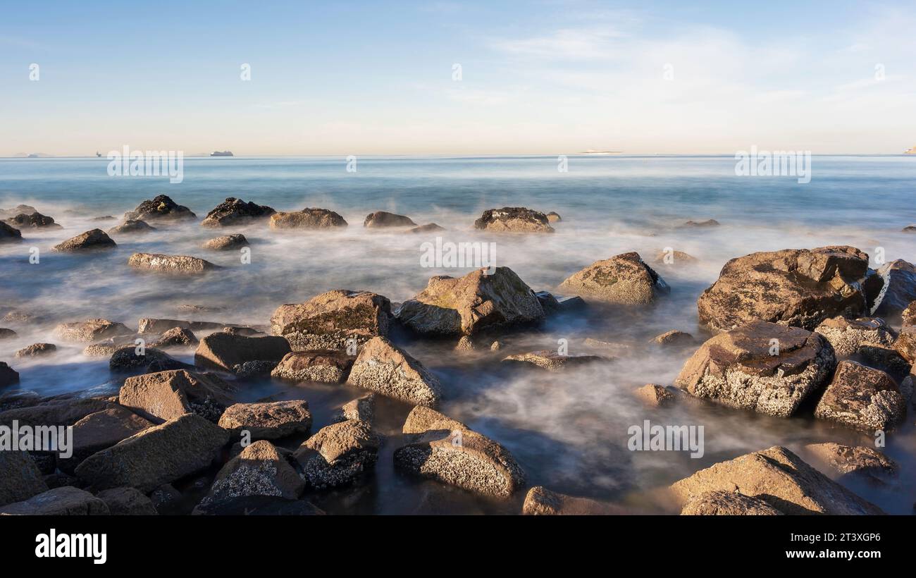 Rocks on the shoreline of a California Beach. Long Exposure so the sea ...