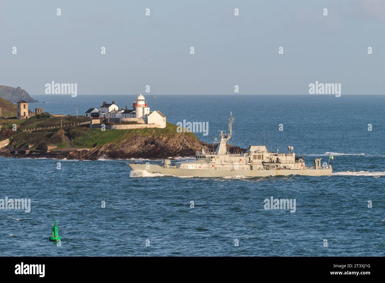 Irish Naval vessel 'William Butler Yeats' passes Roches Point lighthouse on the way into Cork Harbour. Stock Photo