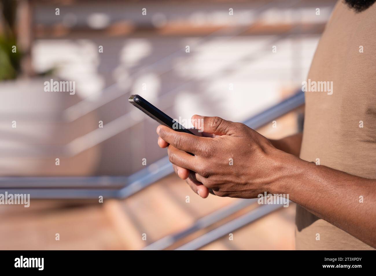 close up of young black using smartphone app outdoors. Stock Photo