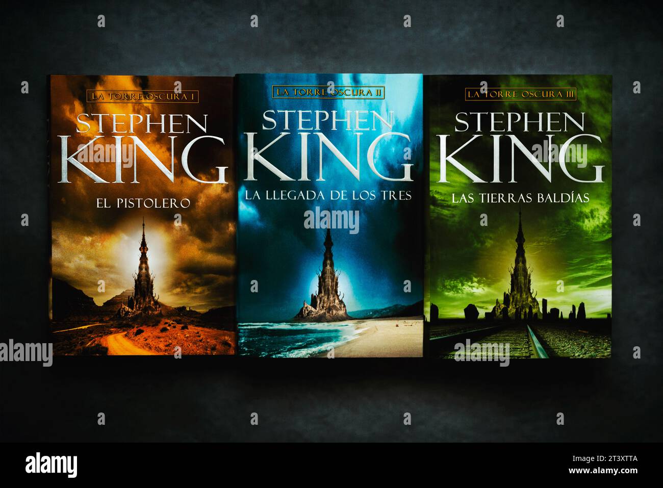 Books in Spanish from the Dark Tower series by American novelist Stephen King over grunge background Stock Photo