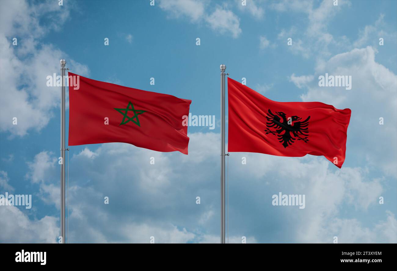 Morocco and Albania flags waving together in the wind on blue cloudy ...