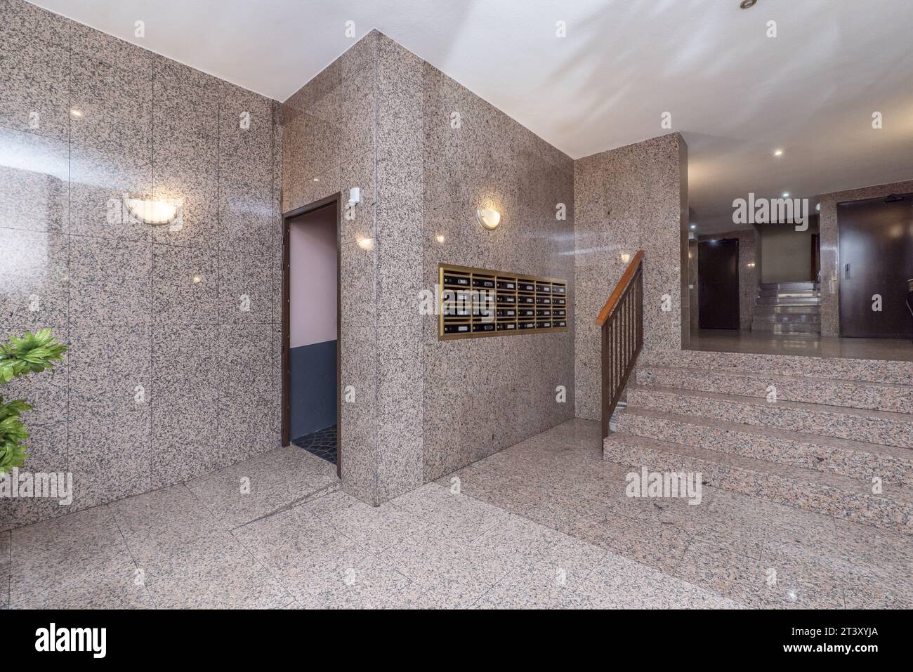 Hallway of a residential apartment building with pink polished granite