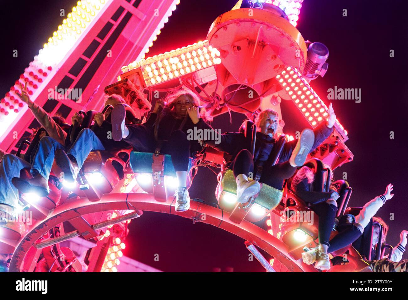 People enjoying a fairground ride at night, the Stratford upon Avon Mop