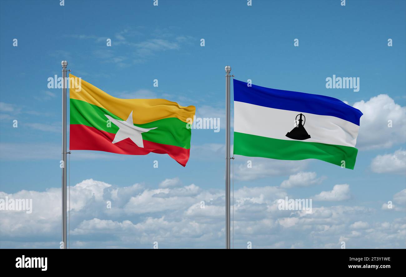 Lesotho and Myanmar flags waving together in the wind on blue cloudy ...