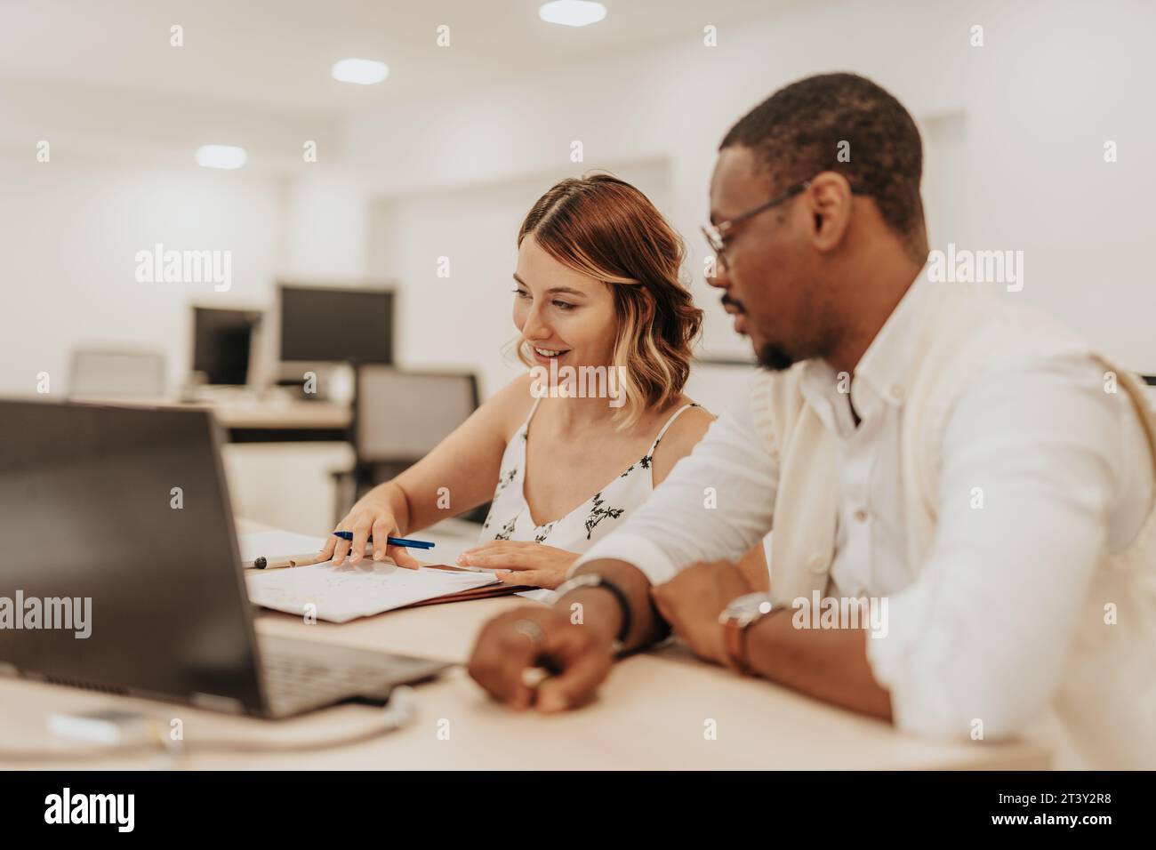 Multiracial Team Collaborating on Strategic Business Plan Stock Photo