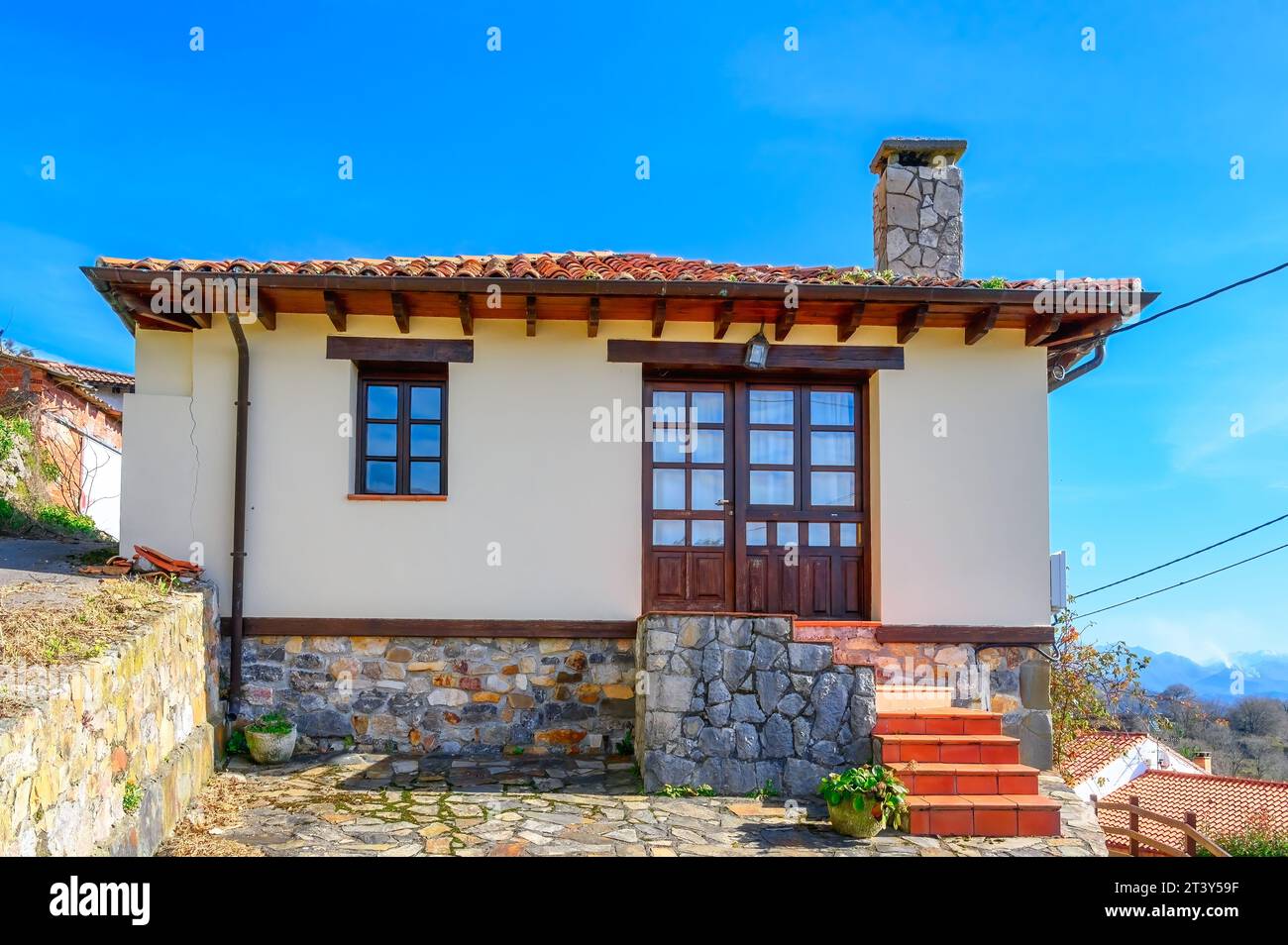Facade of a rural house in a valley. The building exterior has a ...