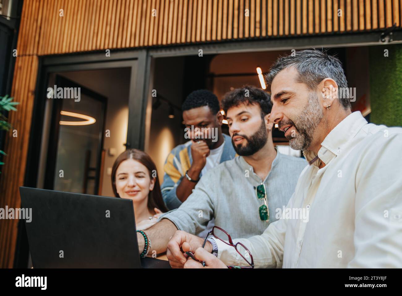 Diverse professionals collaborate in a modern office, brainstorming ...