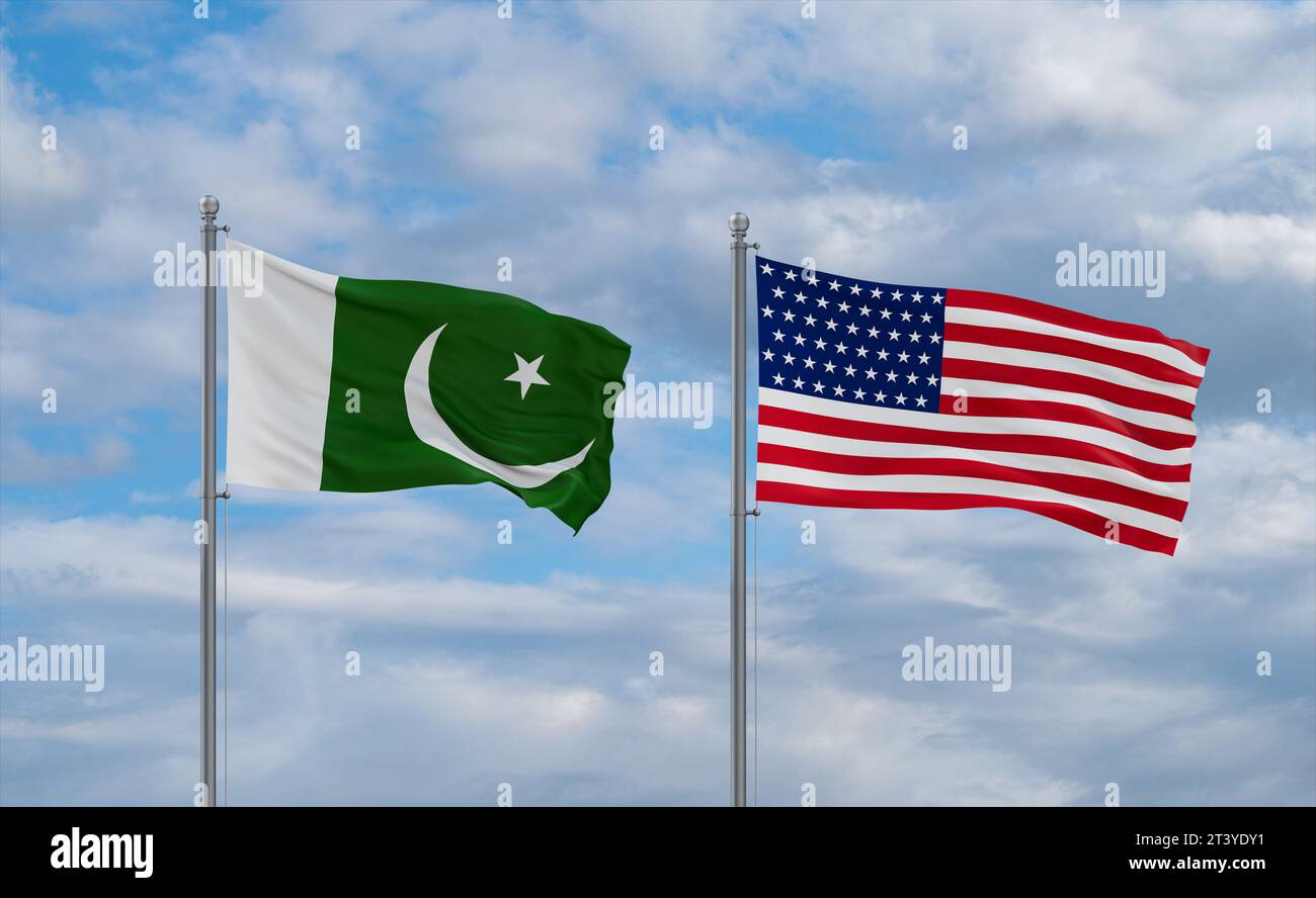 USA and Pakistan flags waving together in the wind on blue cloudy sky, two country relationship concept Stock Photo