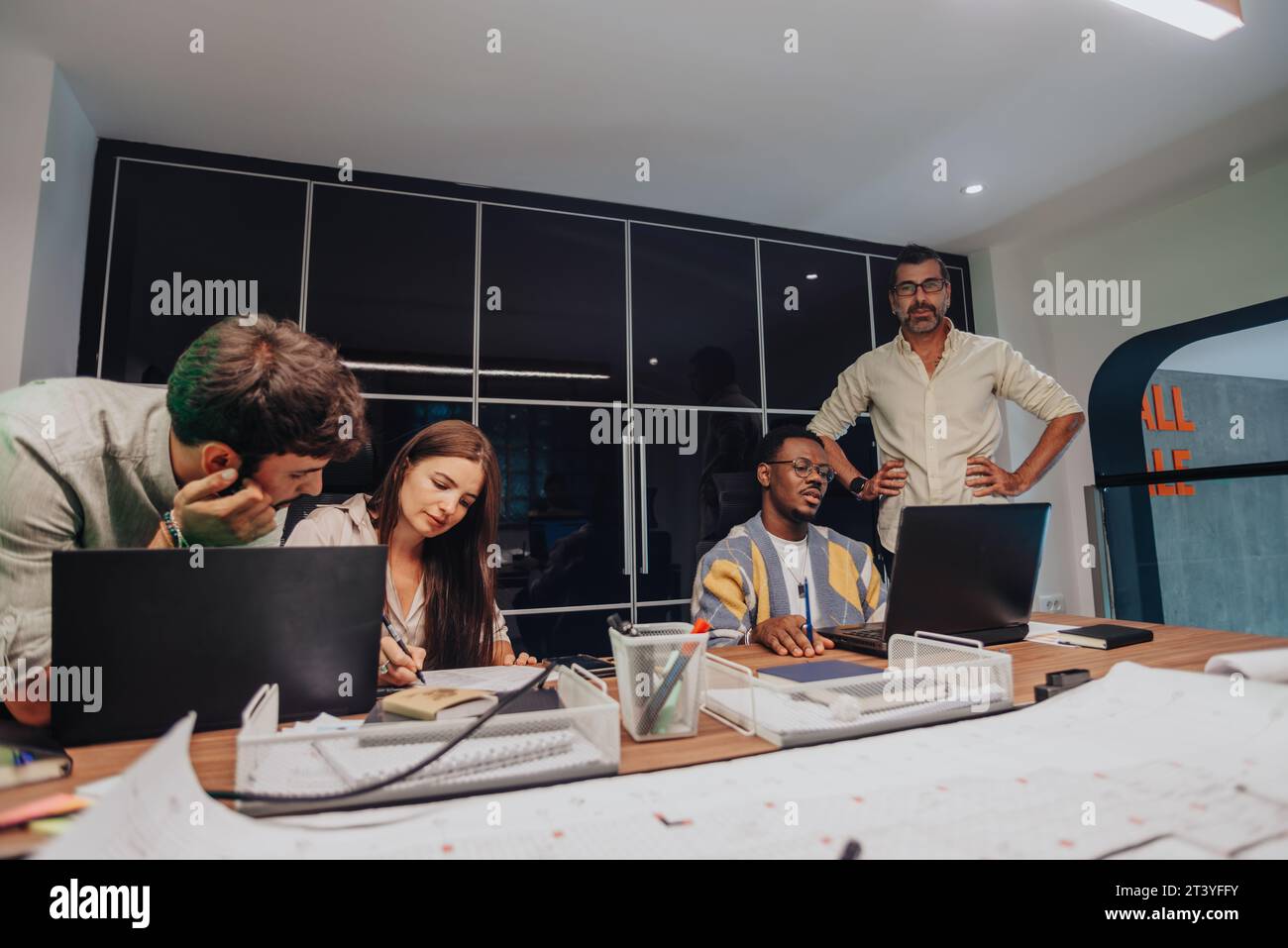Multiracial colleagues brainstorming in a modern boardroom. Creative ...
