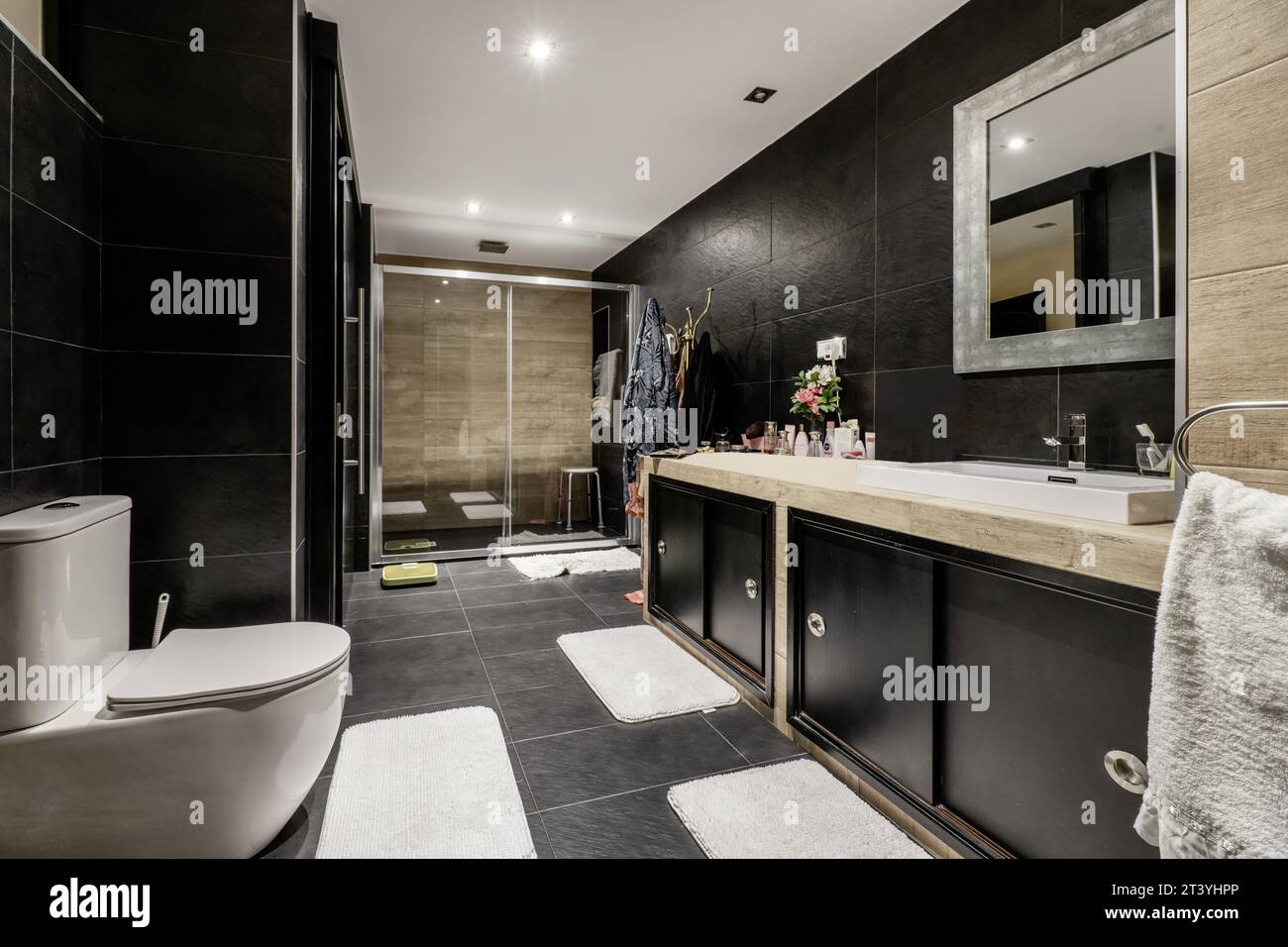 Large Fully tiled bathroom with black slate tiles, black wooden vanity ...