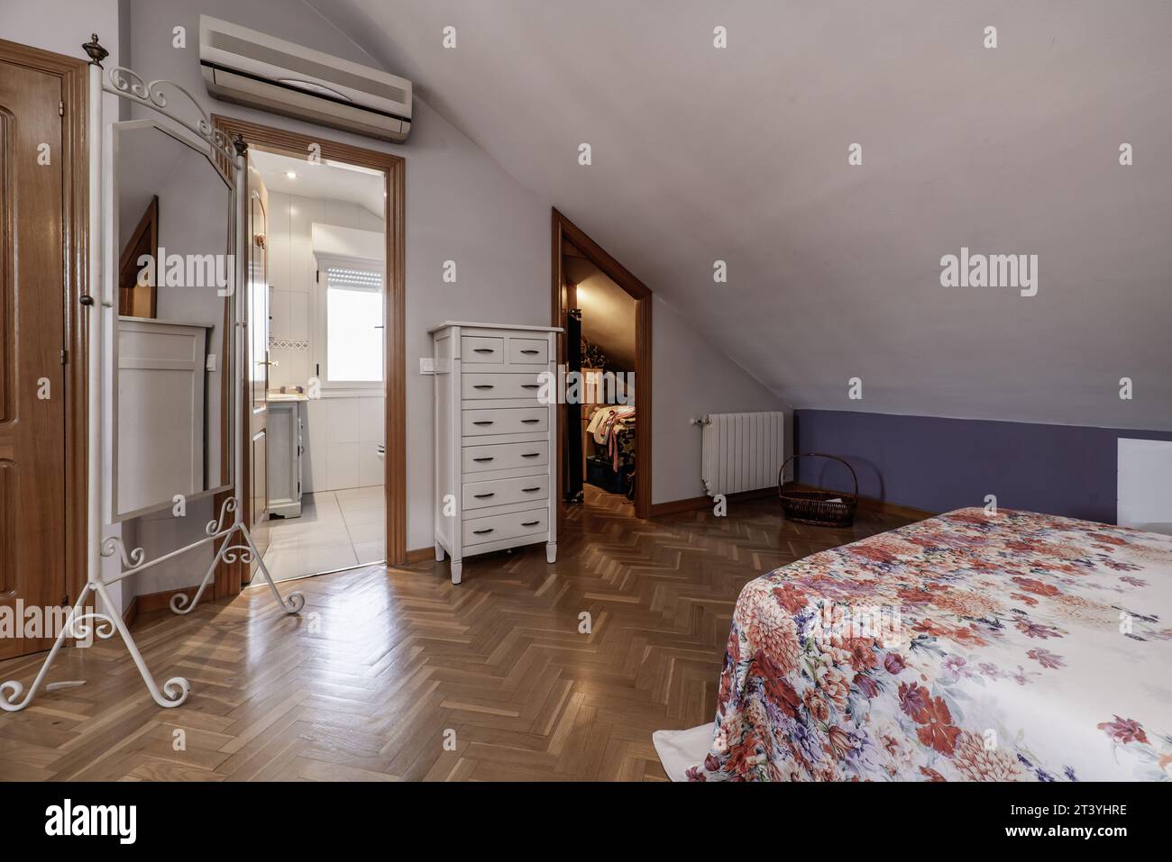 Attic floor bedroom with sloping ceilings, en-suite bathroom Stock Photo