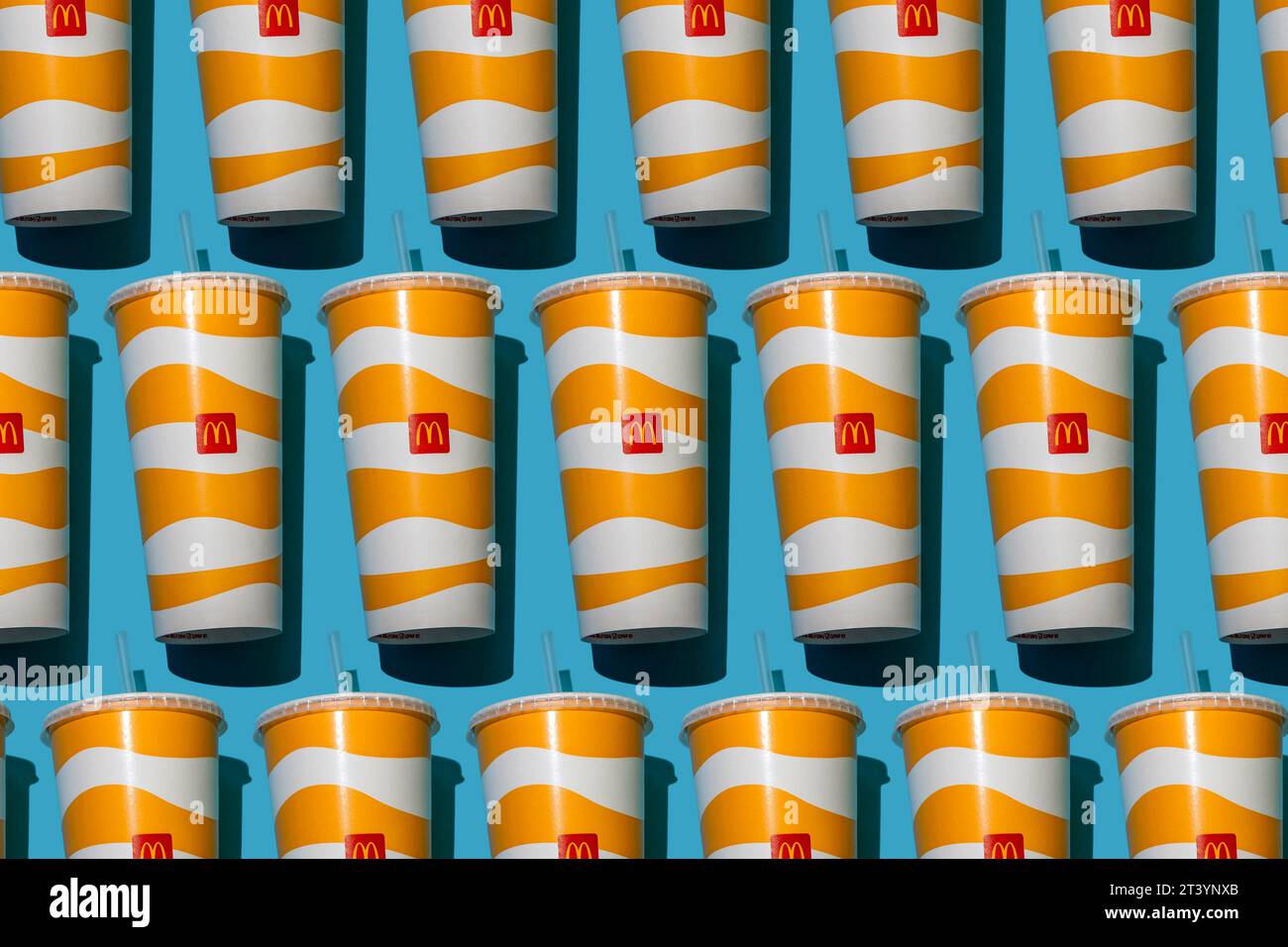 Yellow glass of McDonald's. Paper cup with lid. Takeaway drink ...