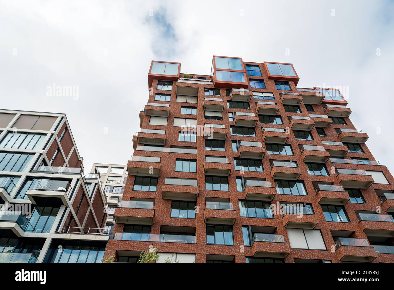 Modern housing building with balconies and brick facade Stock Photo - Alamy