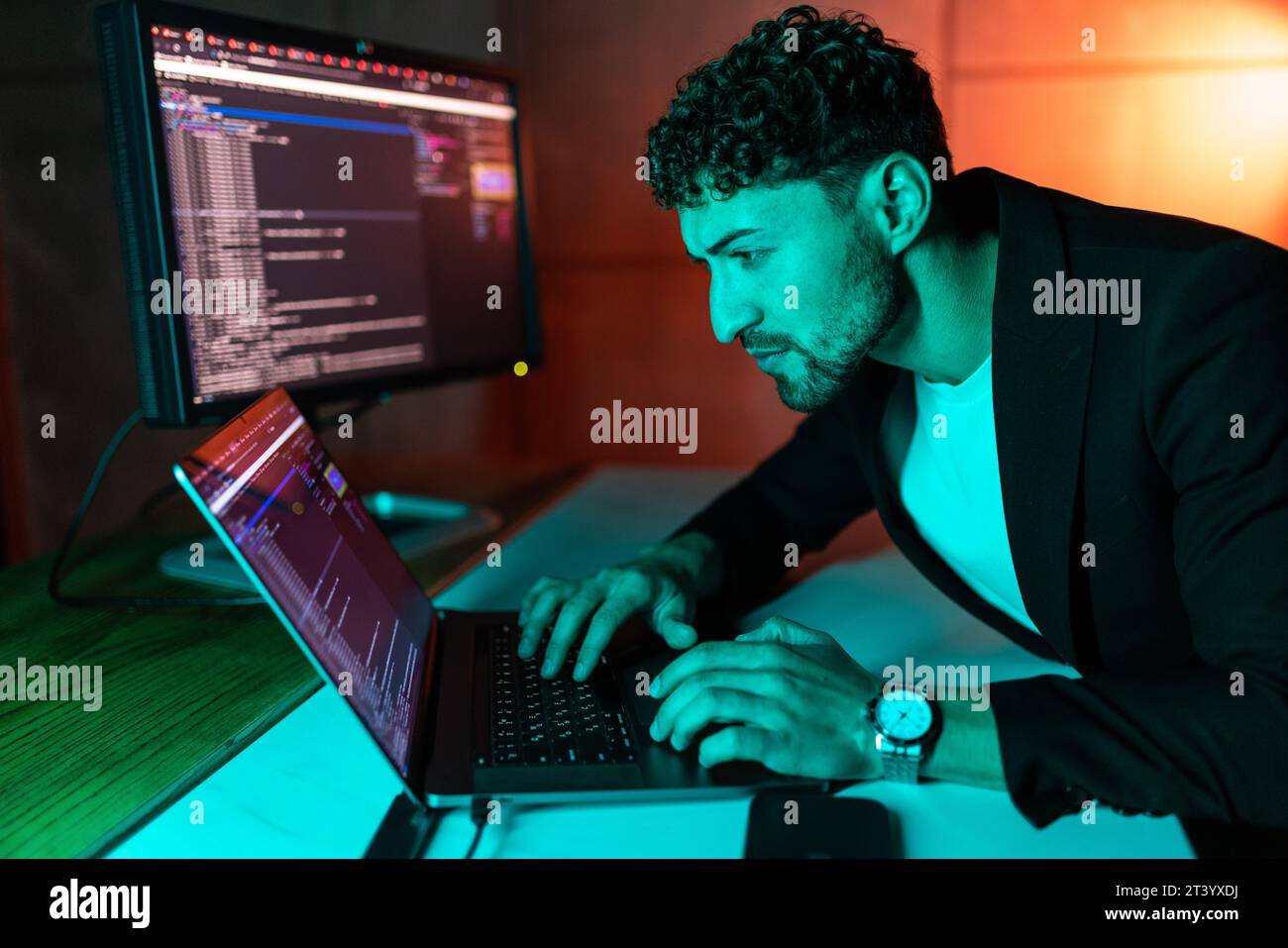 Handsome young programmer working at home late in evening Stock Photo