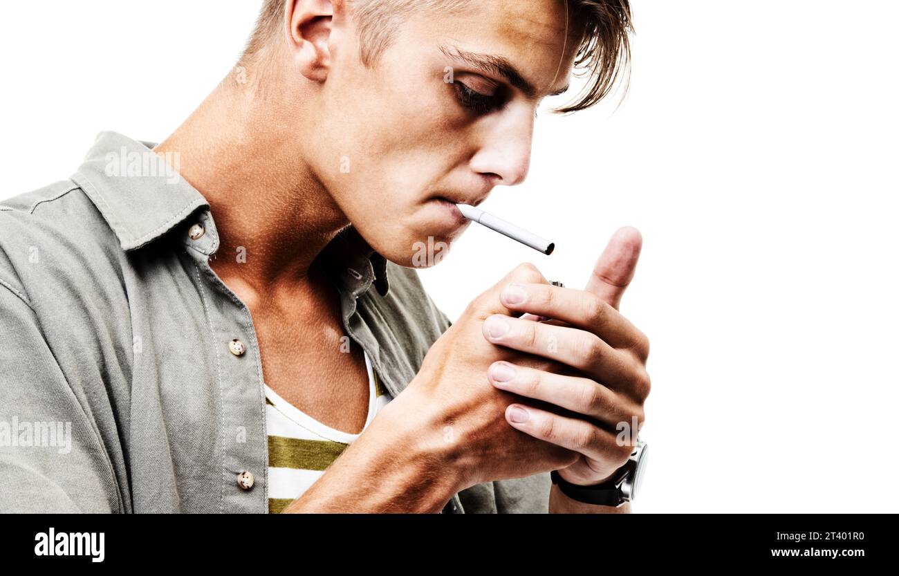 Stress, studio and man lighting a cigarette with a lighter to smoke for an addiction or habit to relax. Dangerous, smoker or person from Germany Stock Photo