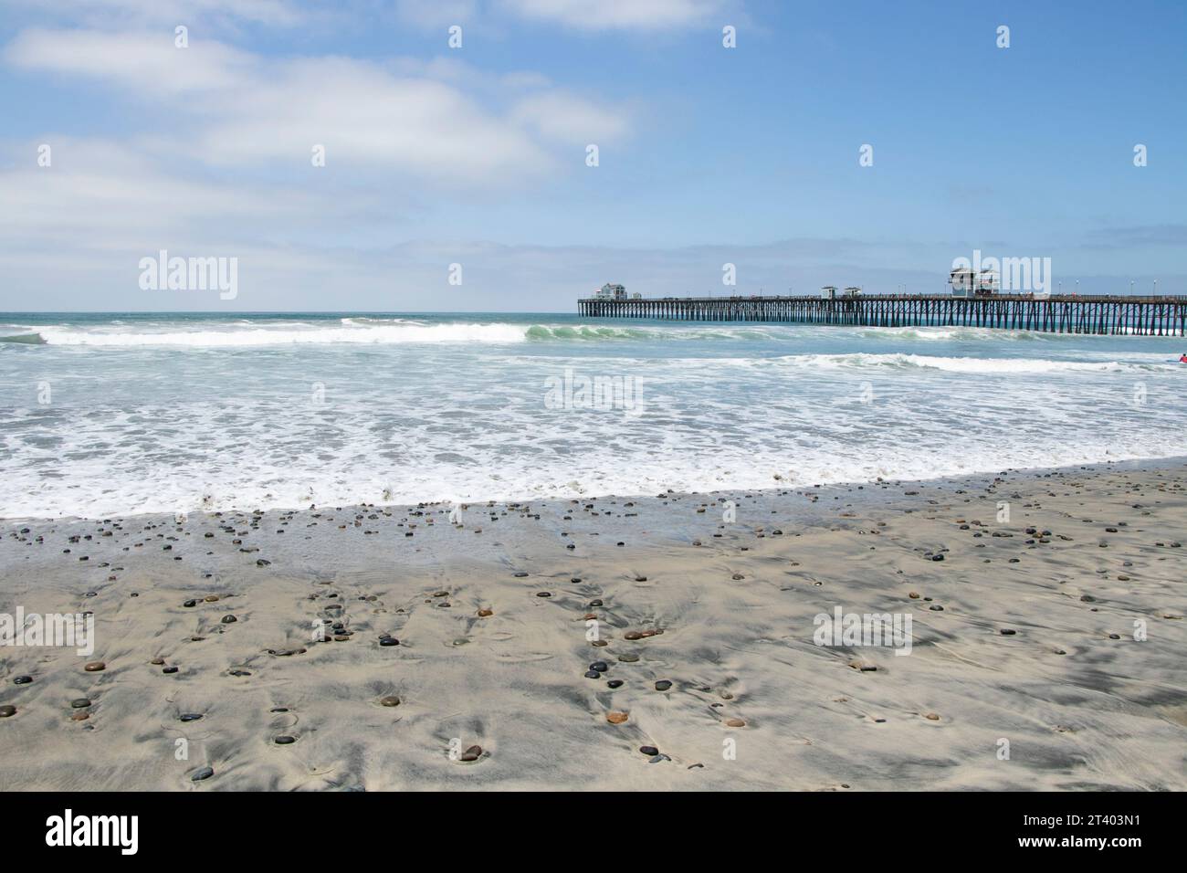 Coast of Pacific Ocean in Oceanside California beach with long wooden pier near San Diego Stock Photo