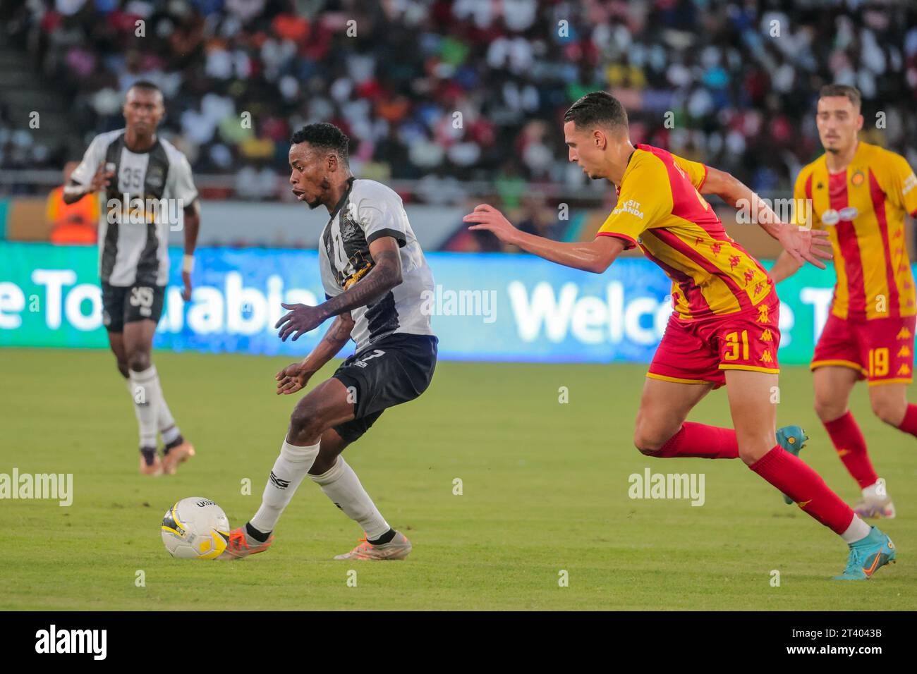 DAR ES SALAAM, TUNISIA – OCTOBER 22:    PHILLIPPES BENI KINZUMBI of Mazembe and Esperance defenders during the African Football League match between T Stock Photo