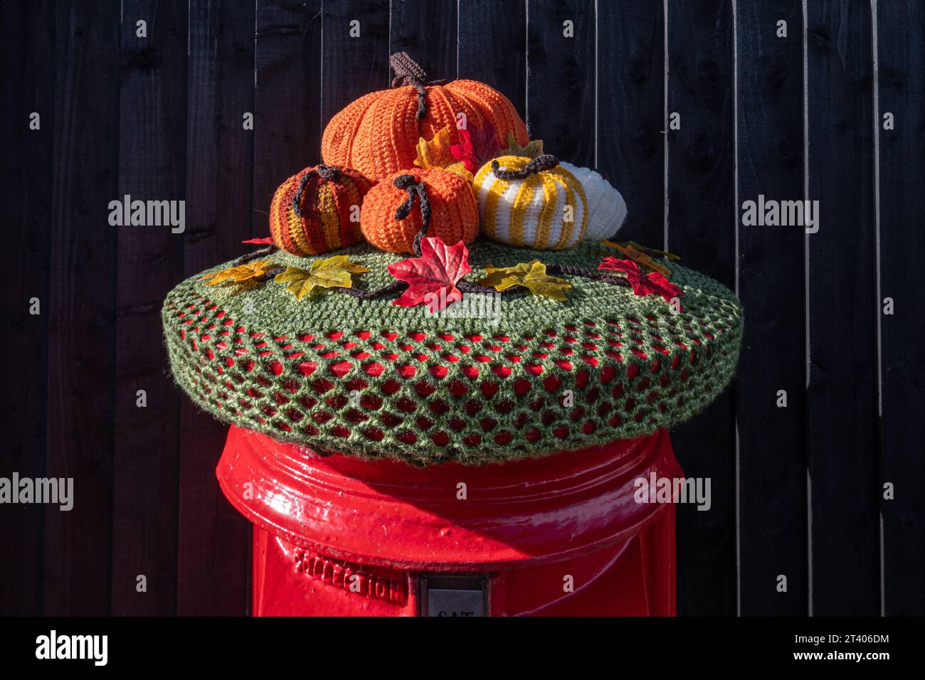 Halloween decorations, pumpkins, yarn bombing on red post box postbox letterbox letterbox