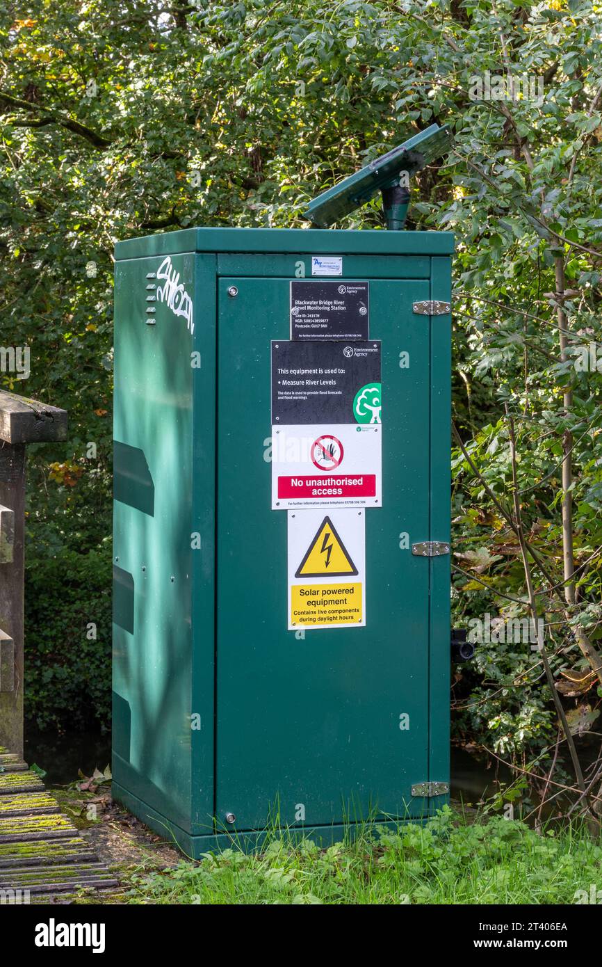 Solar-powered river level monitoring station on the River Blackwater at Blackwater Bridge in Camberley, Surrey, England, UK Stock Photo