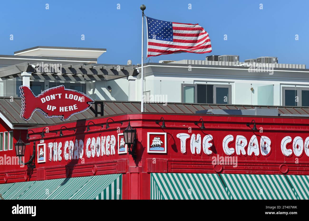 NEWPORT BEACH, CALIFORNIA - 26 OCT 2023: Signs atop The Crab Cooker Fish Market and Restaurant serves one thing, Fish, for over 50 years. Stock Photo