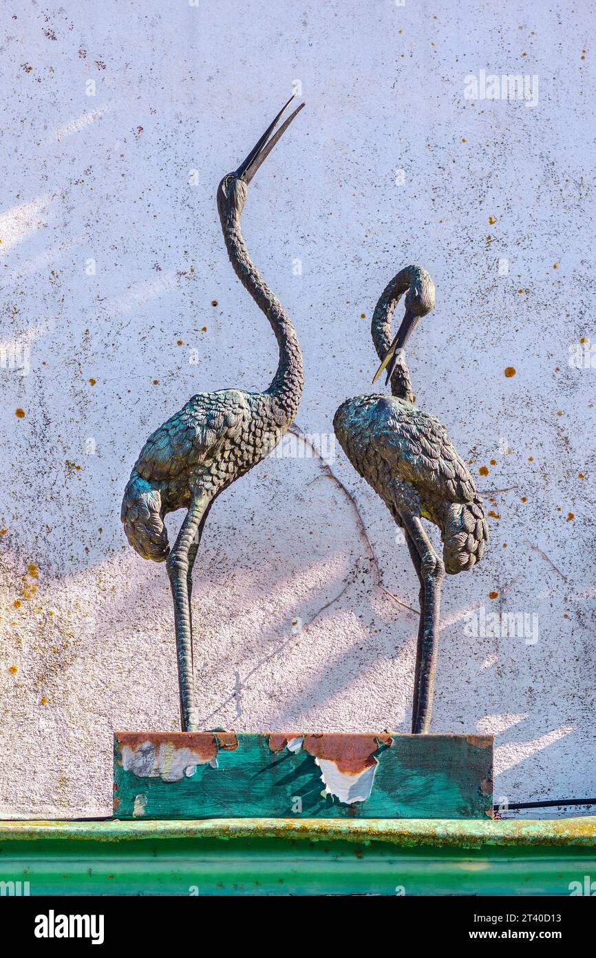 Pair of ornate birds / cranes, in bronze above doorway of vet's office - Preuilly-sur-Claise, Indre-et-Loire (37), France. Stock Photo