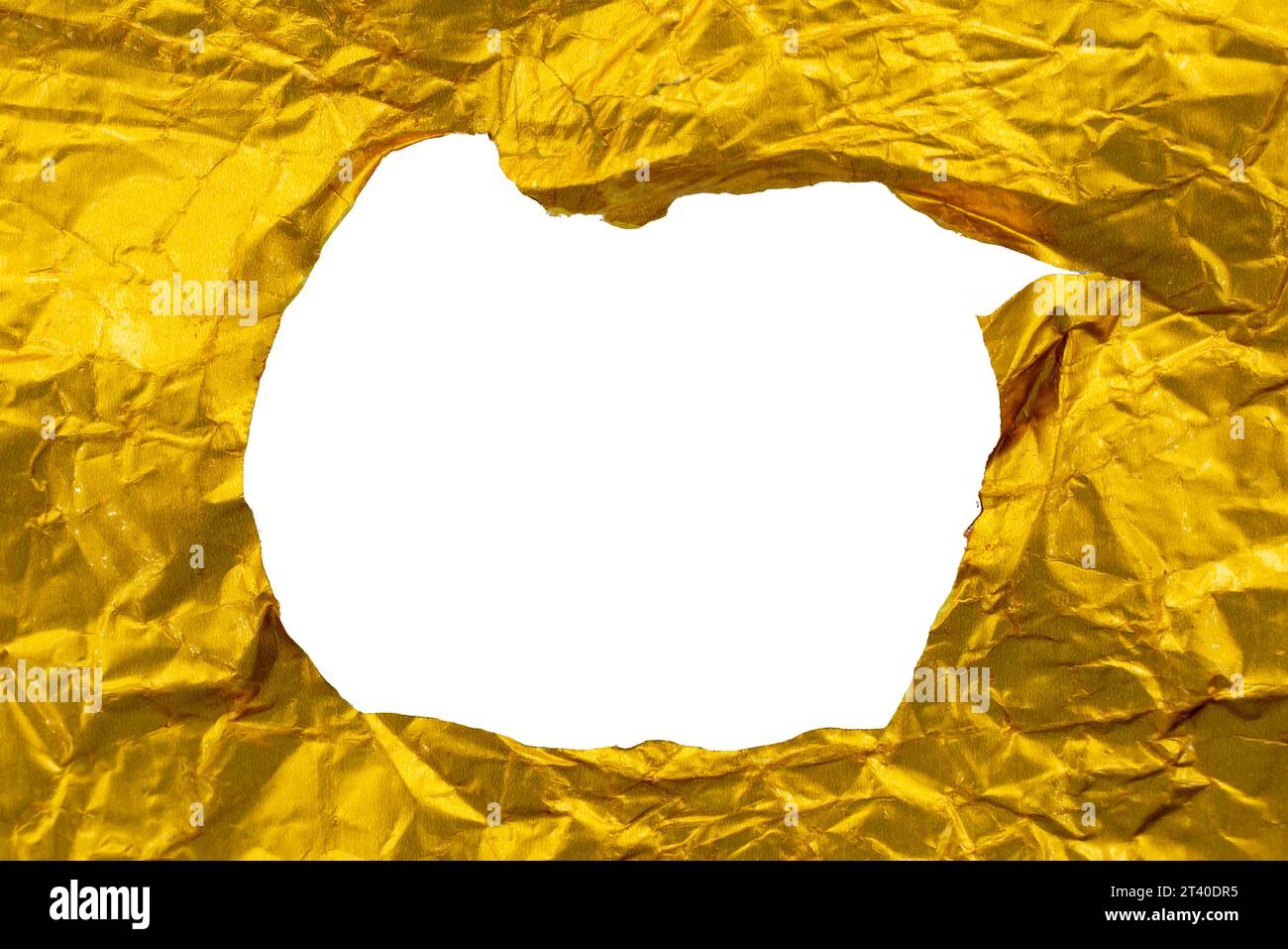 A hole in crumpled yellow foil paper. Hole in paper Stock Photo